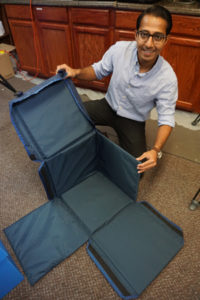MaxQ co-founder Shoaib Shaikh with some of the company's innovative boxes used for blood storage
